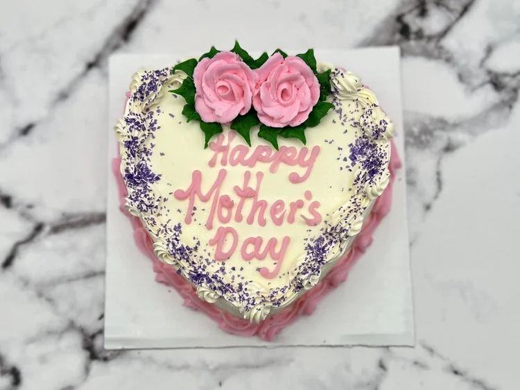 Heart-shaped Happy Mother&rsquo;s Day ice cream cake with pink piped roses and purple sprinkles, at Merla-Mae Ice Cream in London, Ontario