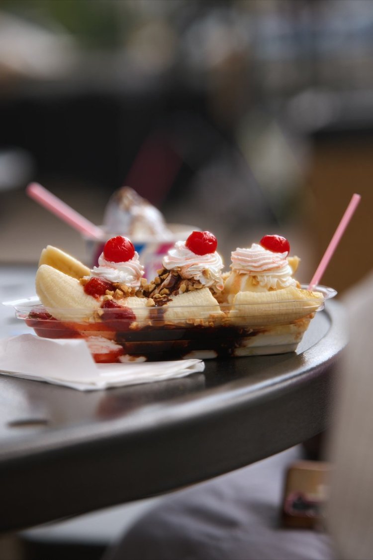A Merla-Mae banana split with whipped cream, cherries and chocolate syrup served at National Ice Cream Day 2026