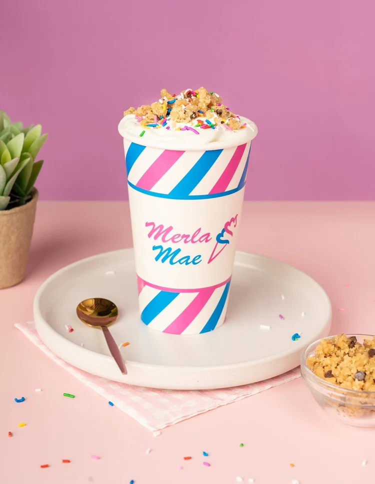 Birthday Cake Cream Shake Flurry topped with rainbow sprinkles in a striped cup at Merla-Mae Ice Cream in London, Ontario