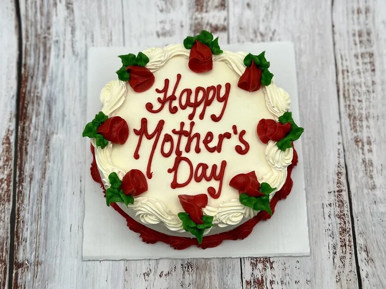 Round Happy Mother&rsquo;s Day ice cream cake ringed with red icing rosebuds and a red piped border, at Merla-Mae Ice Cream in London, Ontario
