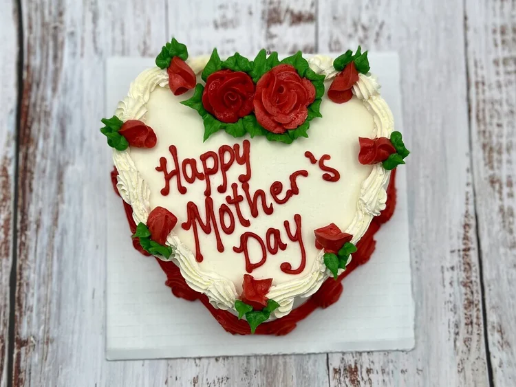 Heart-shaped Happy Mother&rsquo;s Day ice cream cake with red icing roses and rosebuds and a red piped border, at Merla-Mae Ice Cream in London, Ontario