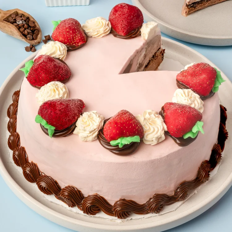 Pink ice cream cake topped with chocolate-dipped strawberries and whipped cream at Merla-Mae Ice Cream in London, Ontario