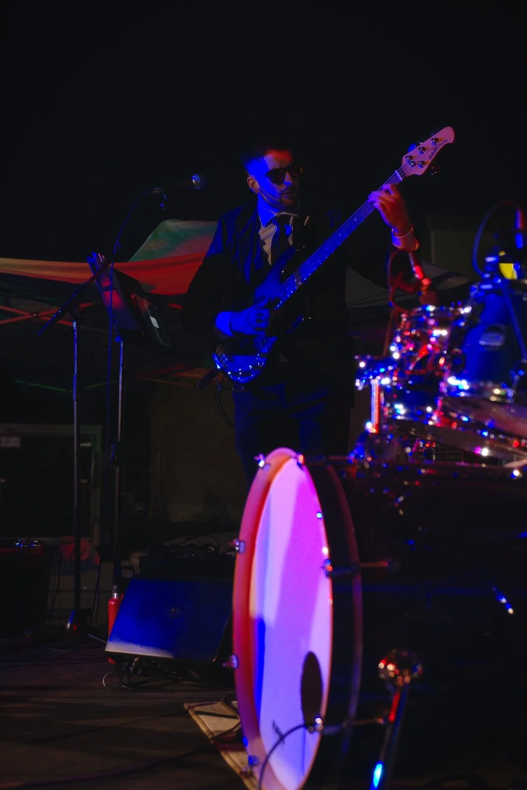 Turning Corners' bassist under the lights at National Ice Cream Day 2026, Merla-Mae