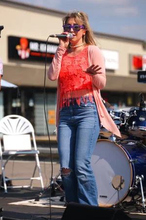 Sweet Theory lead singer performing at Merla-Mae Ice Cream in London, Ontario
