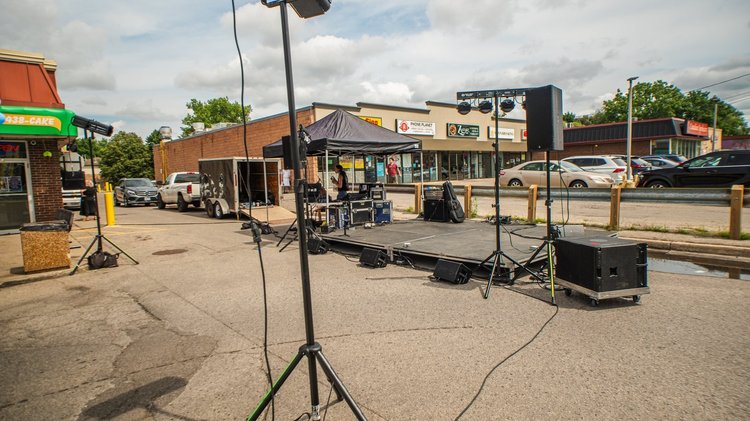 The outdoor stage and speakers set up in the parking lot before the music at National Ice Cream Day 2025, Merla-Mae Ice Cream in London, Ontario