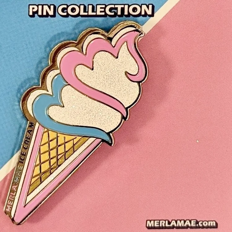 Pin #003 Merla-Mae Logo Cone sparkle enamel pin in pink, white and blue, on its Pin Collection card