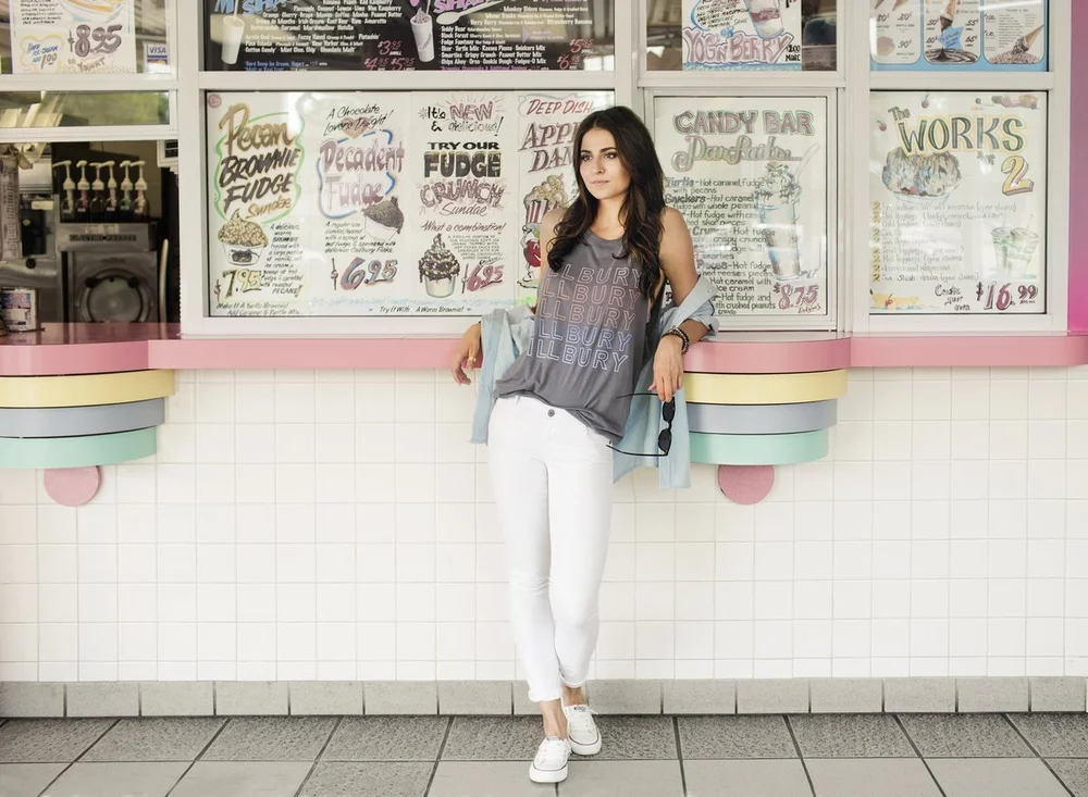 Model wearing an Illbury & Goose tank top at the menu-board counter of Merla-Mae Ice Cream in London, Ontario