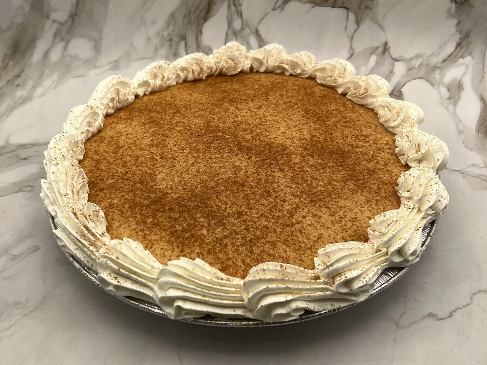 Whole pumpkin ice cream pie dusted with cinnamon and ringed with whipped cream rosettes, from Merla-Mae Ice Cream in London, Ontario