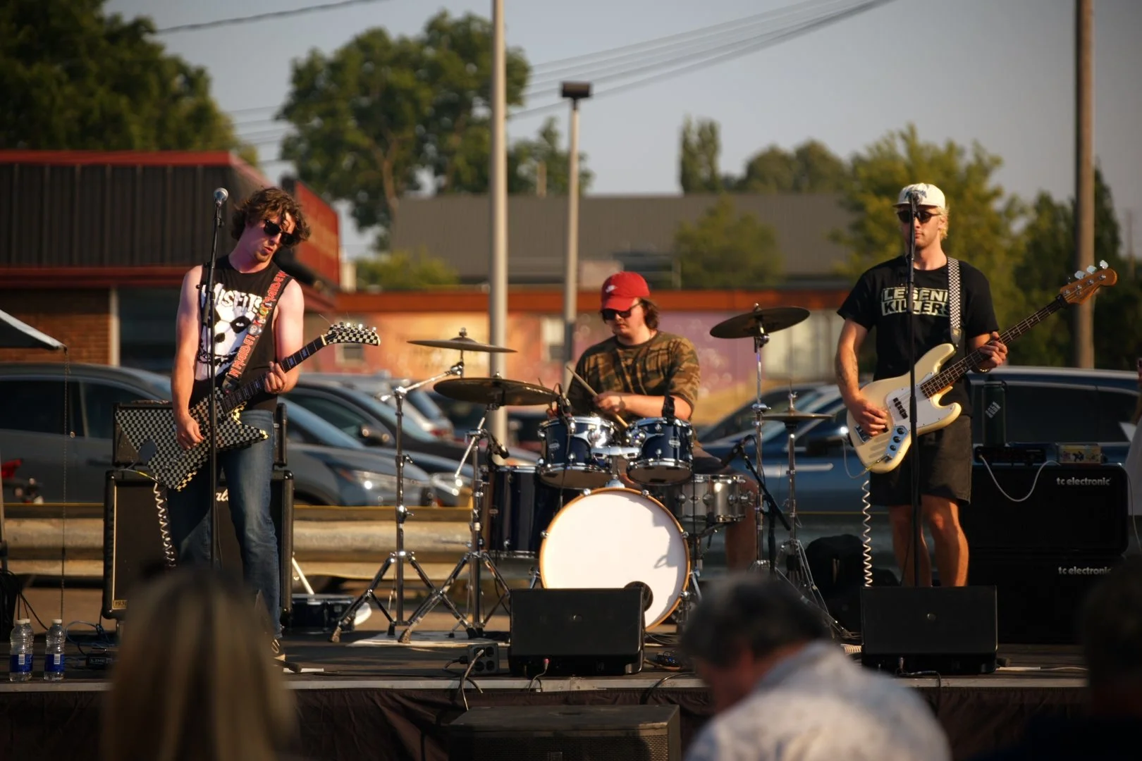 The three members of Full Throttle on the parking-lot stage at National Ice Cream Day 2026, Merla-Mae