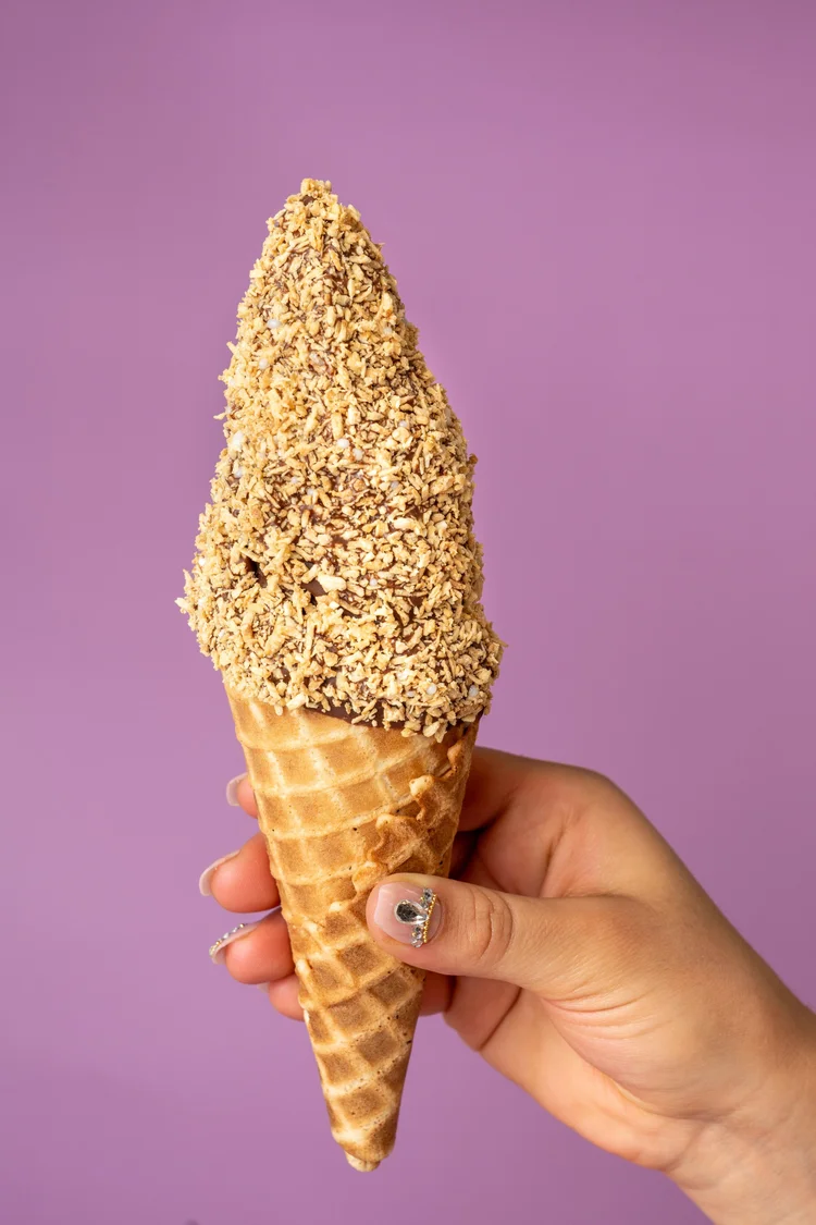 Vanilla soft-serve dipped in chocolate and rolled in peanuts on a homemade waffle cone at Merla-Mae Ice Cream in London, Ontario