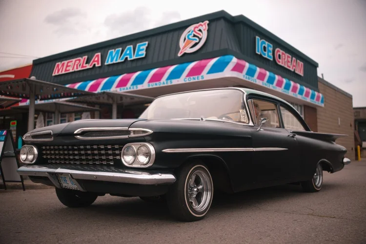 1959 Chevrolet lowrider parked outside Merla-Mae Ice Cream at the Chrome & Cones Car Show