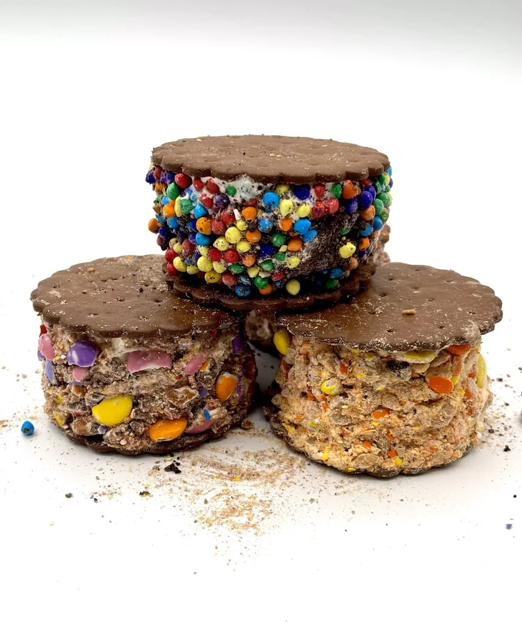 Three ice cream sandwiches rolled edge to edge in colourful candy at Merla-Mae Ice Cream in London, Ontario