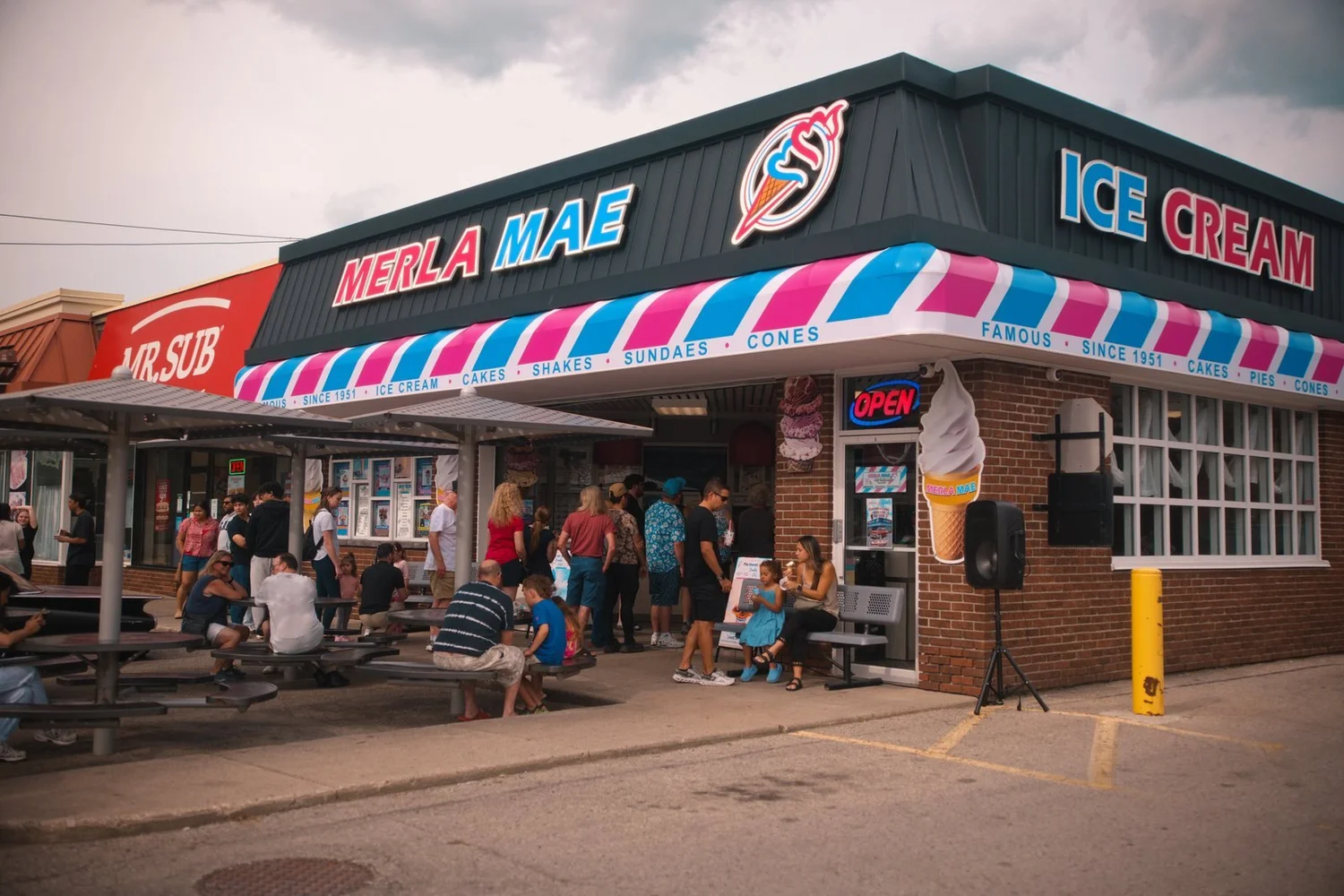 Crowds gathered at the picnic tables outside Merla-Mae Ice Cream during the Annual Car Show in London, Ontario