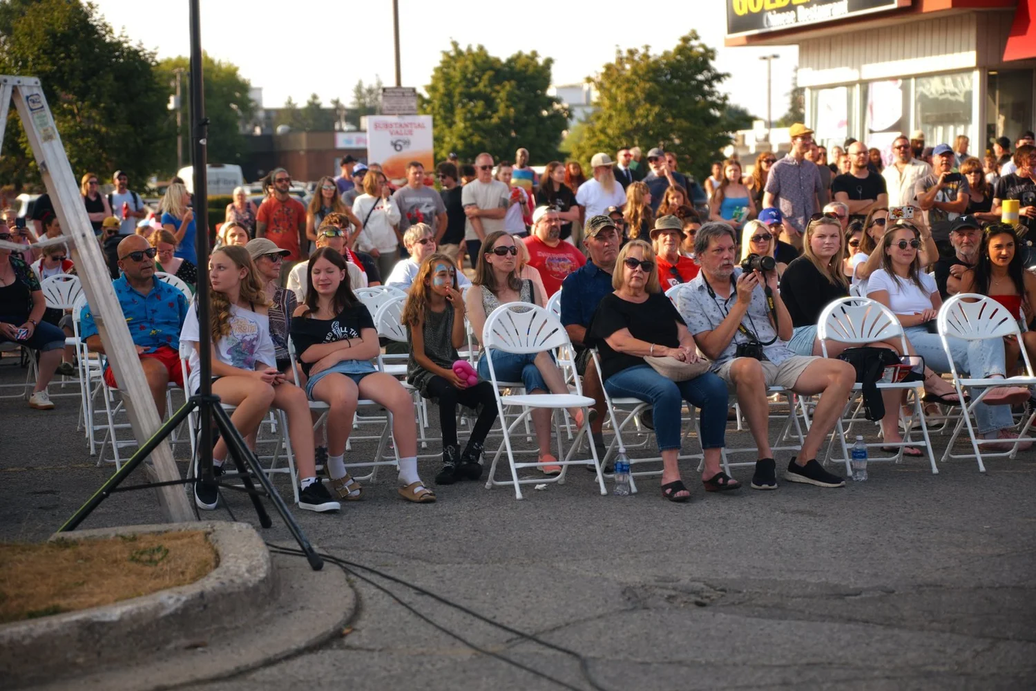 Rows of guests watching the free parking-lot concert at National Ice Cream Day 2026, Merla-Mae Ice Cream in London, Ontario