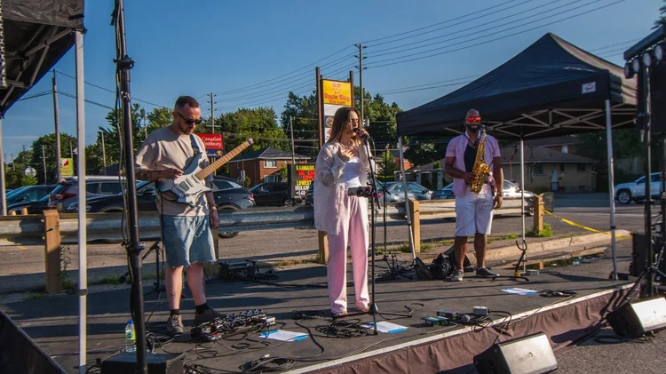 Lyubov Kay and her band performing on the outdoor stage at Merla-Mae&rsquo;s National Ice Cream Day concert
