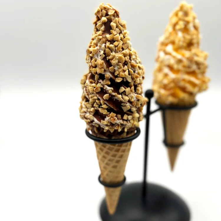 Chocolate-dipped and butterscotch-dipped ice cream drumsticks rolled in chopped nuts on a cone stand at Merla-Mae Ice Cream in London, Ontario