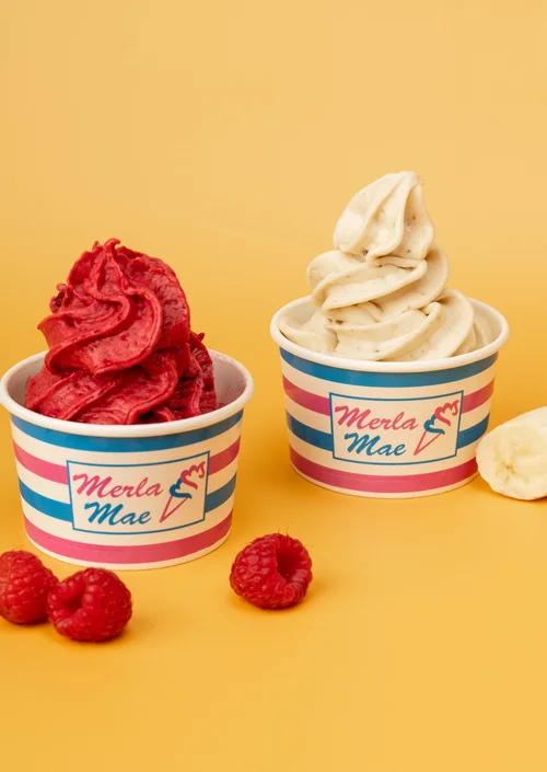 Two frozen yogurt cups with fresh raspberries at Merla-Mae Ice Cream