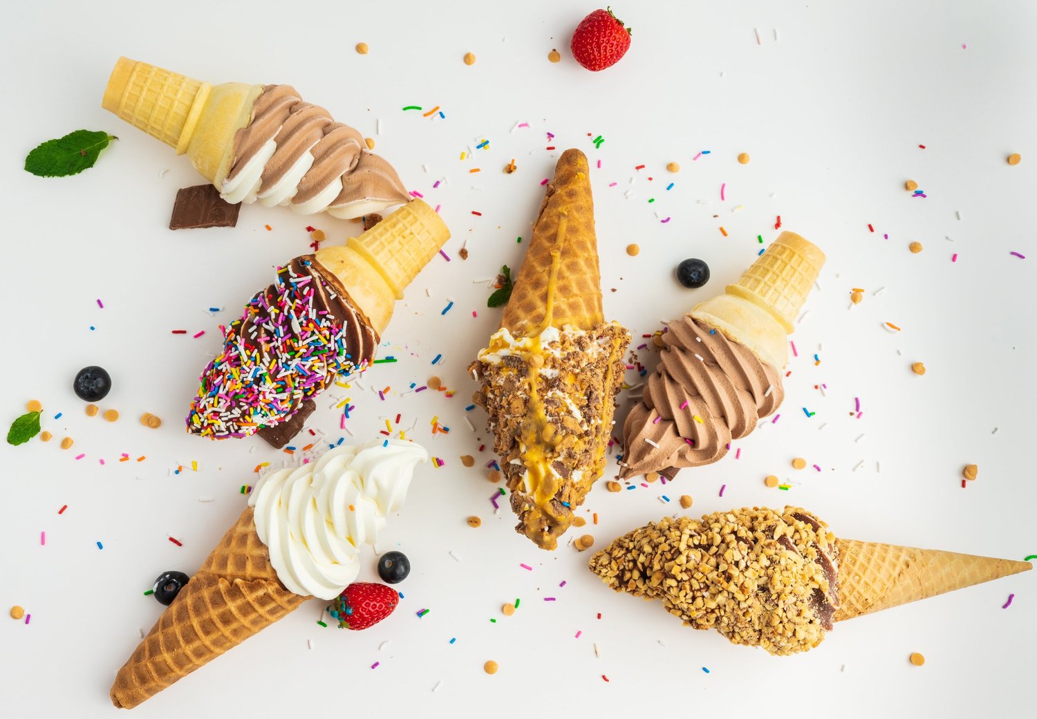 Vanilla, chocolate and twist soft-serve cones, dipped and rolled in rainbow sprinkles and crunchy toppings, at Merla-Mae Ice Cream in London, Ontario
