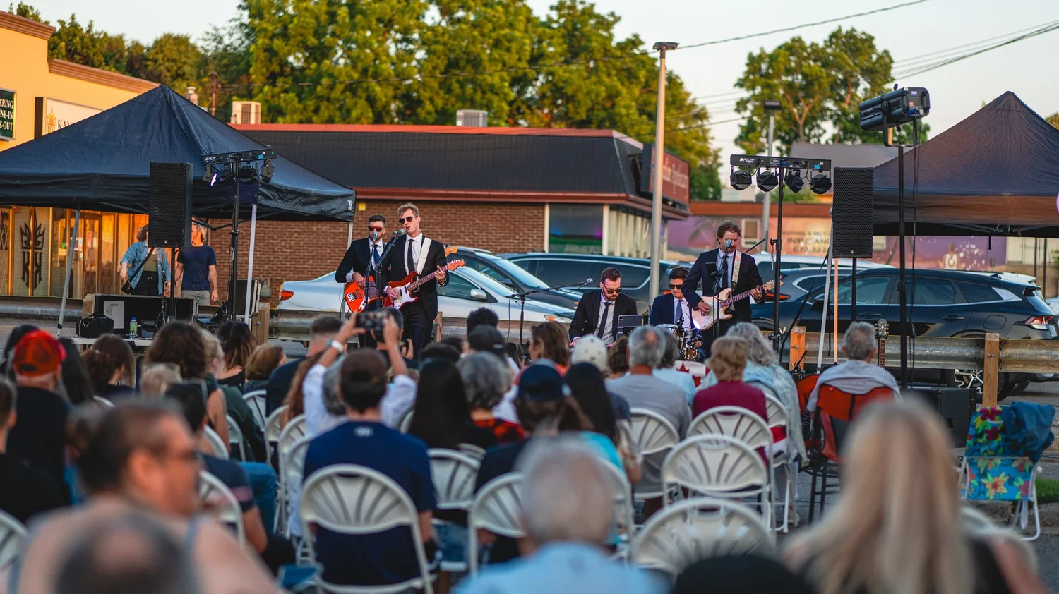 Turning Corners playing the outdoor stage to a seated crowd at National Ice Cream Day at Merla-Mae Ice Cream in London, Ontario