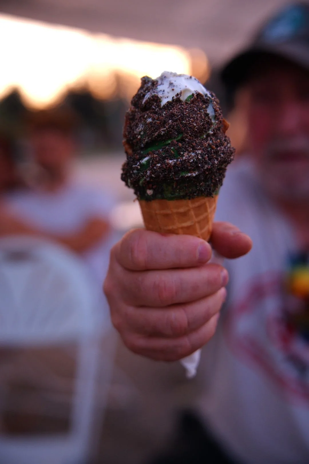 A Merla-Mae soft-serve cone rolled in crushed chocolate cookies at National Ice Cream Day 2026