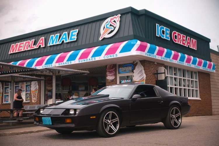 1985 Chevrolet Camaro parked outside Merla-Mae Ice Cream at the Chrome & Cones Car Show