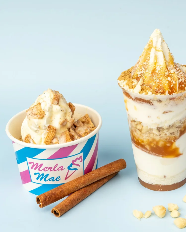 Soft-serve sundae with crunchy cinnamon squares and a caramel-layered soft-serve parfait beside cinnamon sticks, at Merla-Mae Ice Cream in London, Ontario
