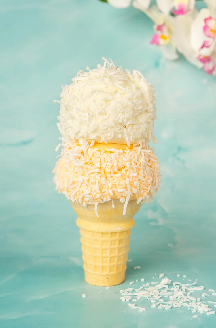 Two scoops of ice cream rolled in shredded coconut on a cake cone at Merla-Mae Ice Cream in London, Ontario