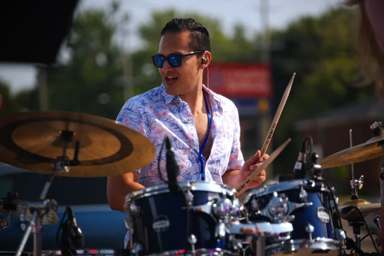 Sweet Theory's drummer performing at Merla-Mae's National Ice Cream Day 2026
