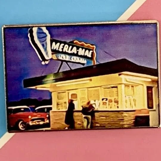 Pin #001 Merla-Mae Classic enamel pin of the original Merla-Mae Ice Cream shack, on its Pin Collection card