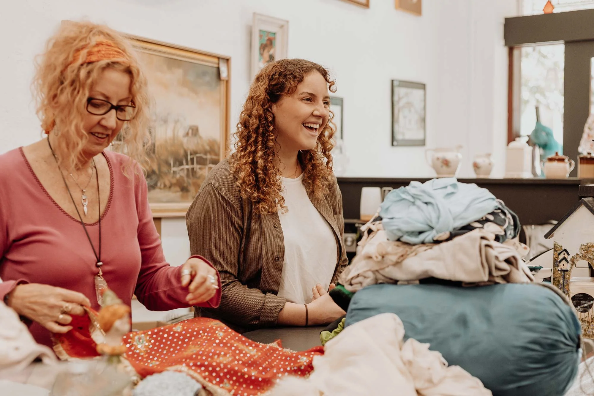 Two smiling Op Shop attendants