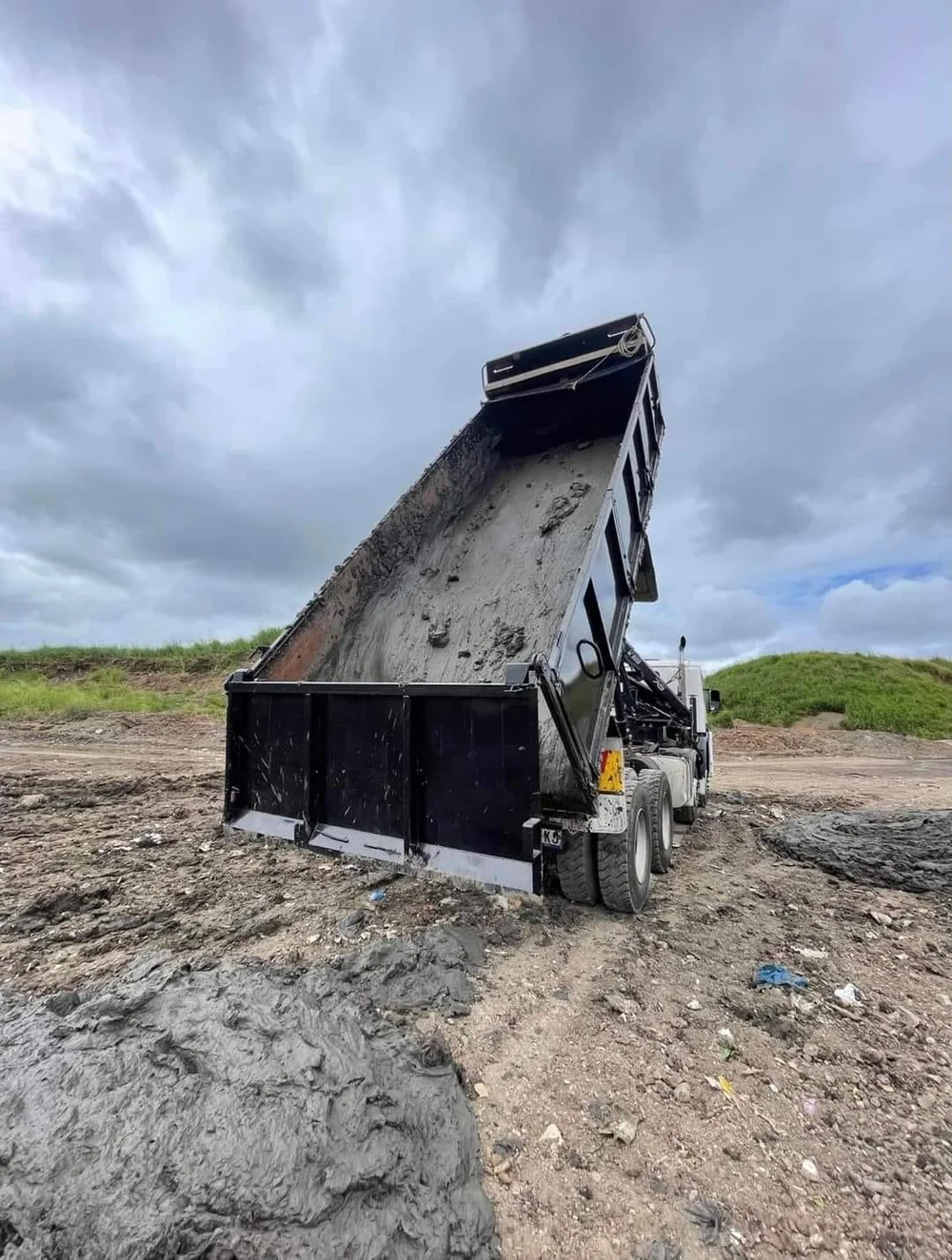 Grab truck tipping a load