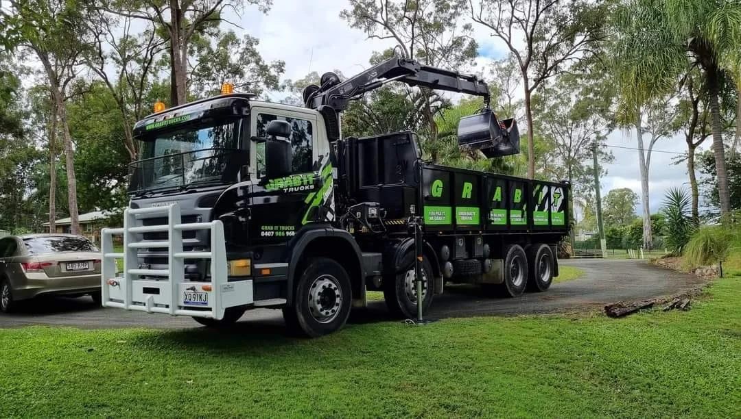 Grab It Trucks grab truck loaded with green waste on site