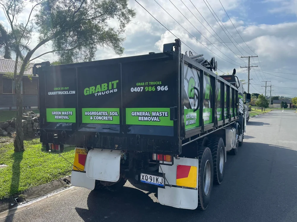 Grab truck removing waste