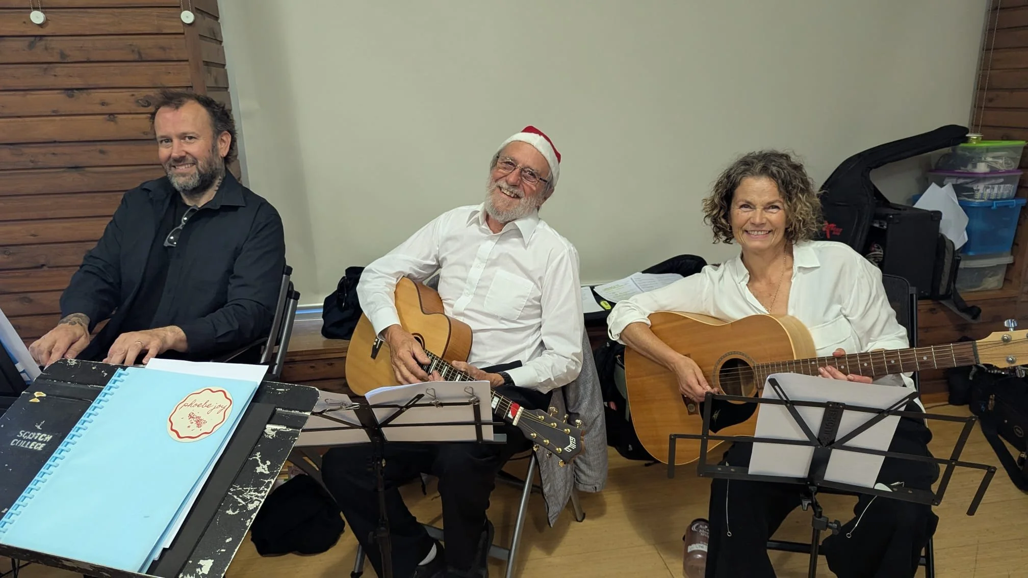 Andrew Phil and Gab play for the community singing.