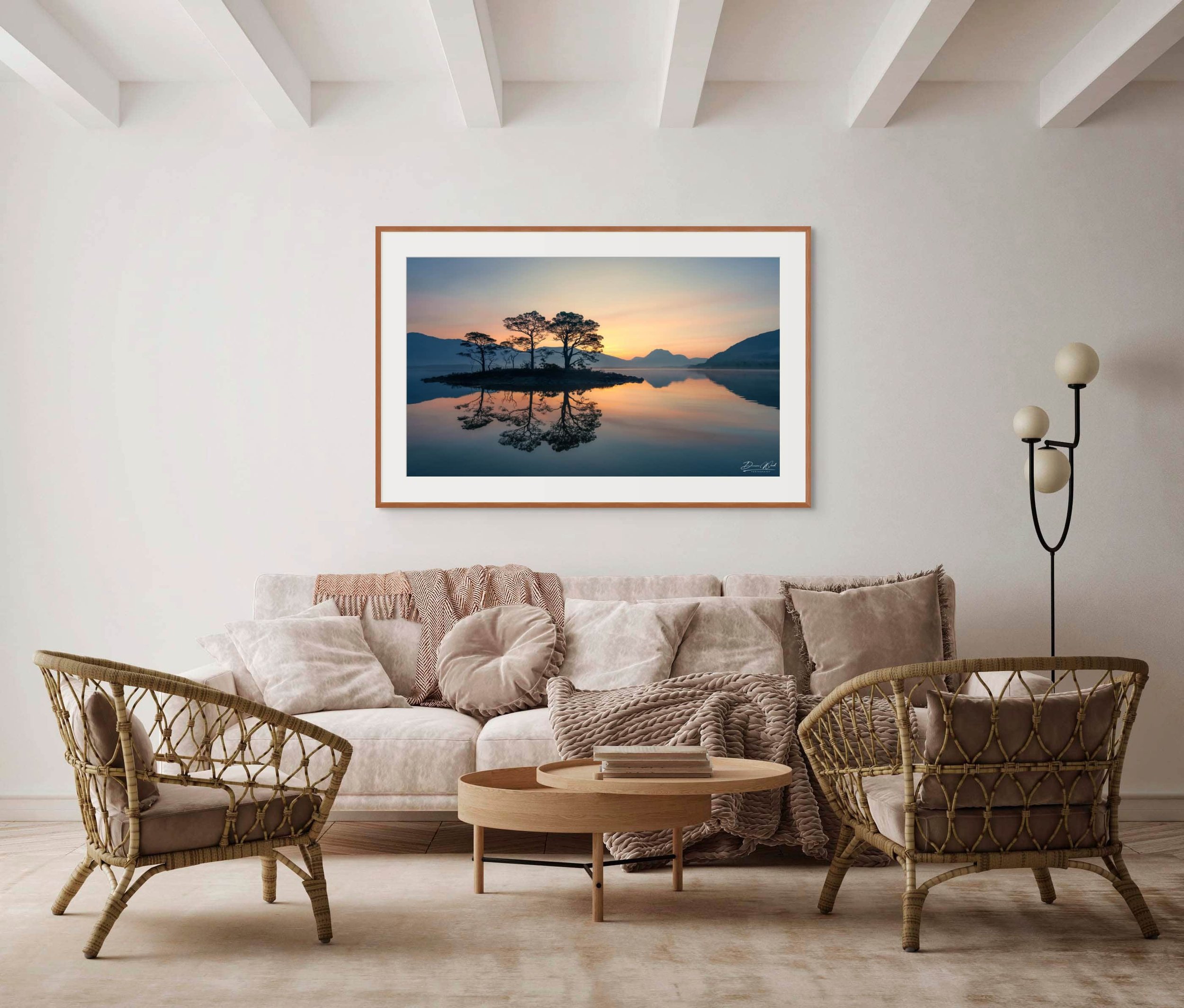Framed print of Whispers of Dawn by Duncan Wood displayed on a wall. Scottish landscape photography with a sunrise reflection at Loch Maree.