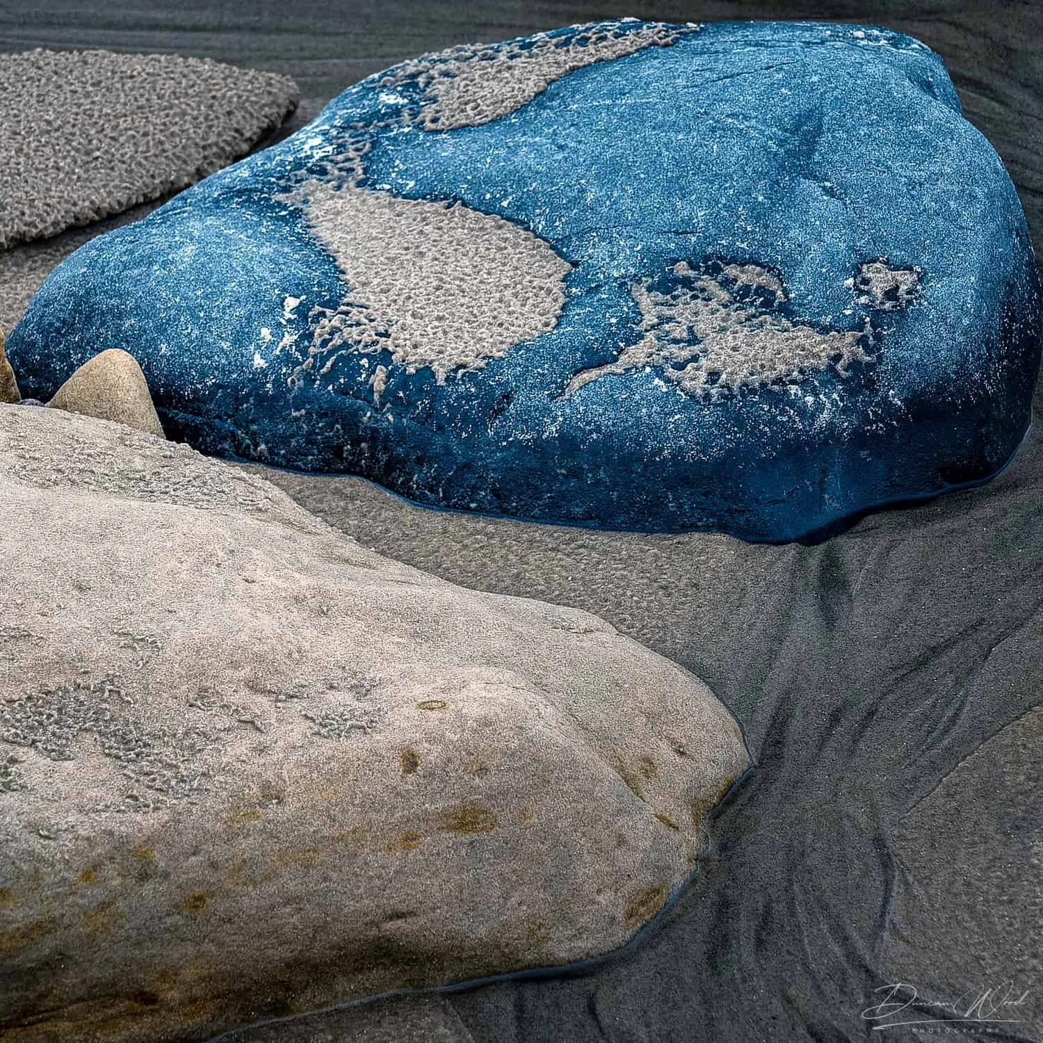 Abstract coastal rock texture with blue tones, natural patterns and close-up detail