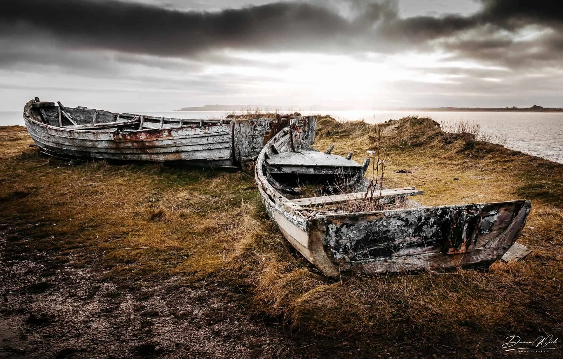 Old boats near the lime kilns at Boddin Point, north east of Lunan Bay on the Angus coast of Scotland.