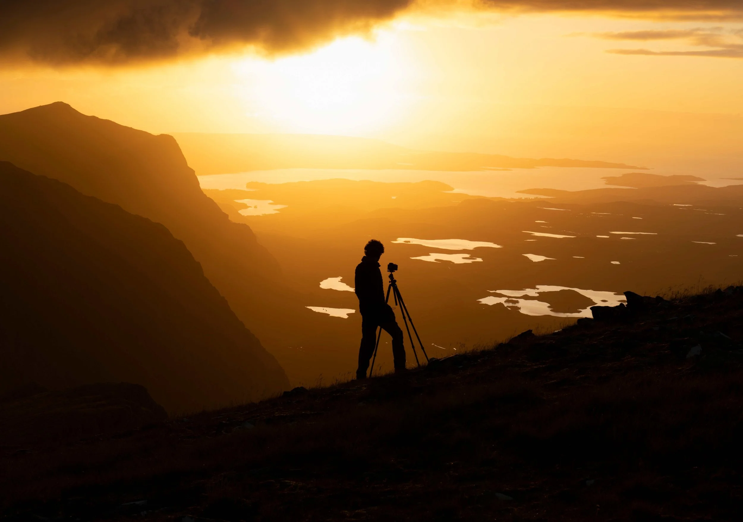 Duncan Wood photographing a mountain landscape at sunset in Scotland