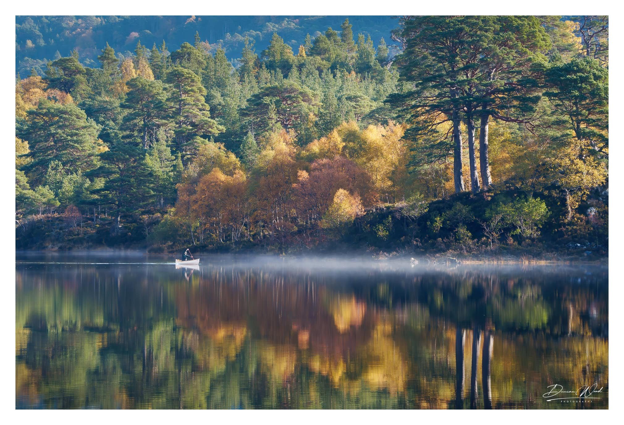 Canoeist on Loch Affric in autumn mist, photographed by Duncan Wood in Scotland. Scottish landscape photography.