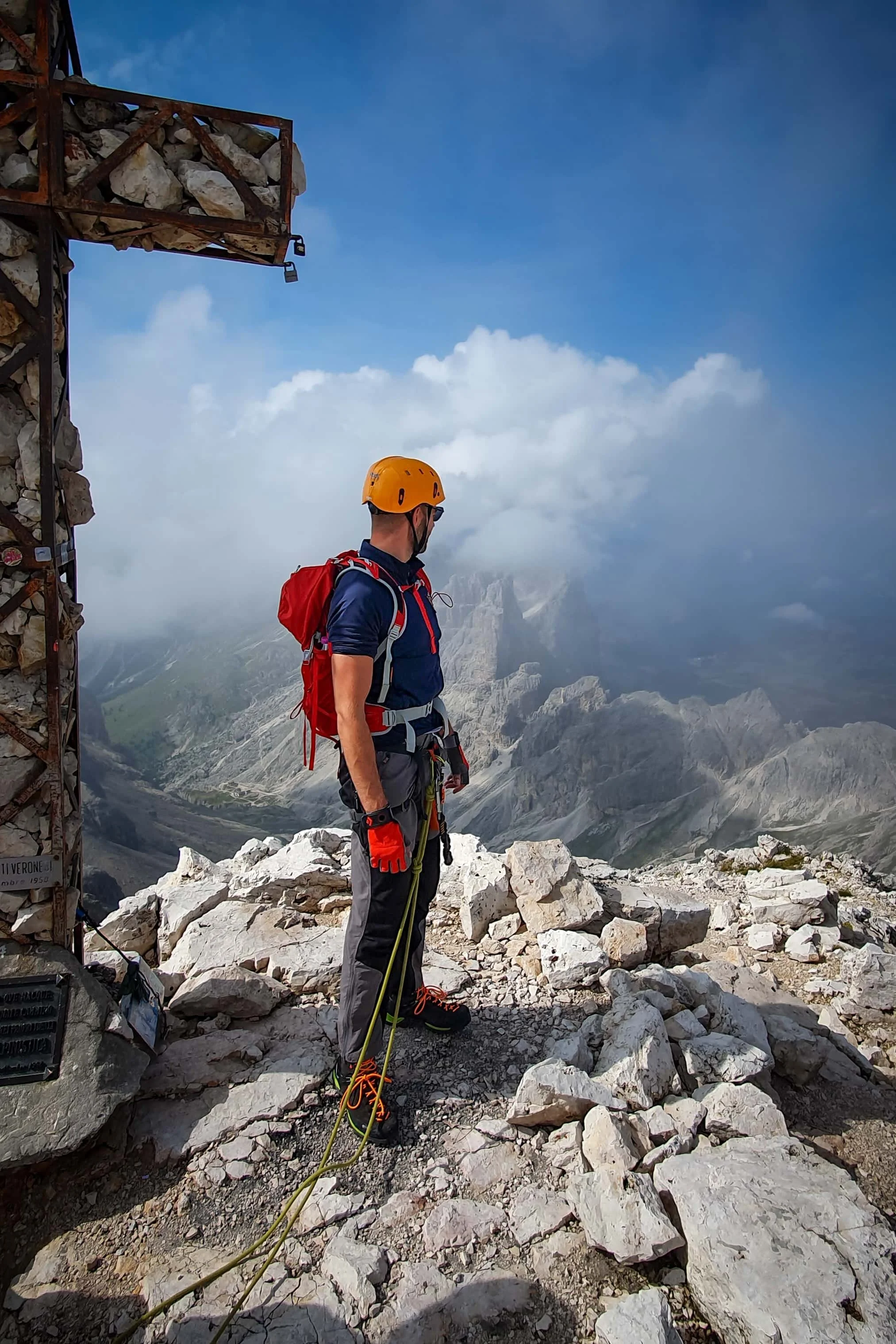 Duncan Wood outdoors in mountain climbing gear looking across a high mountain landscape