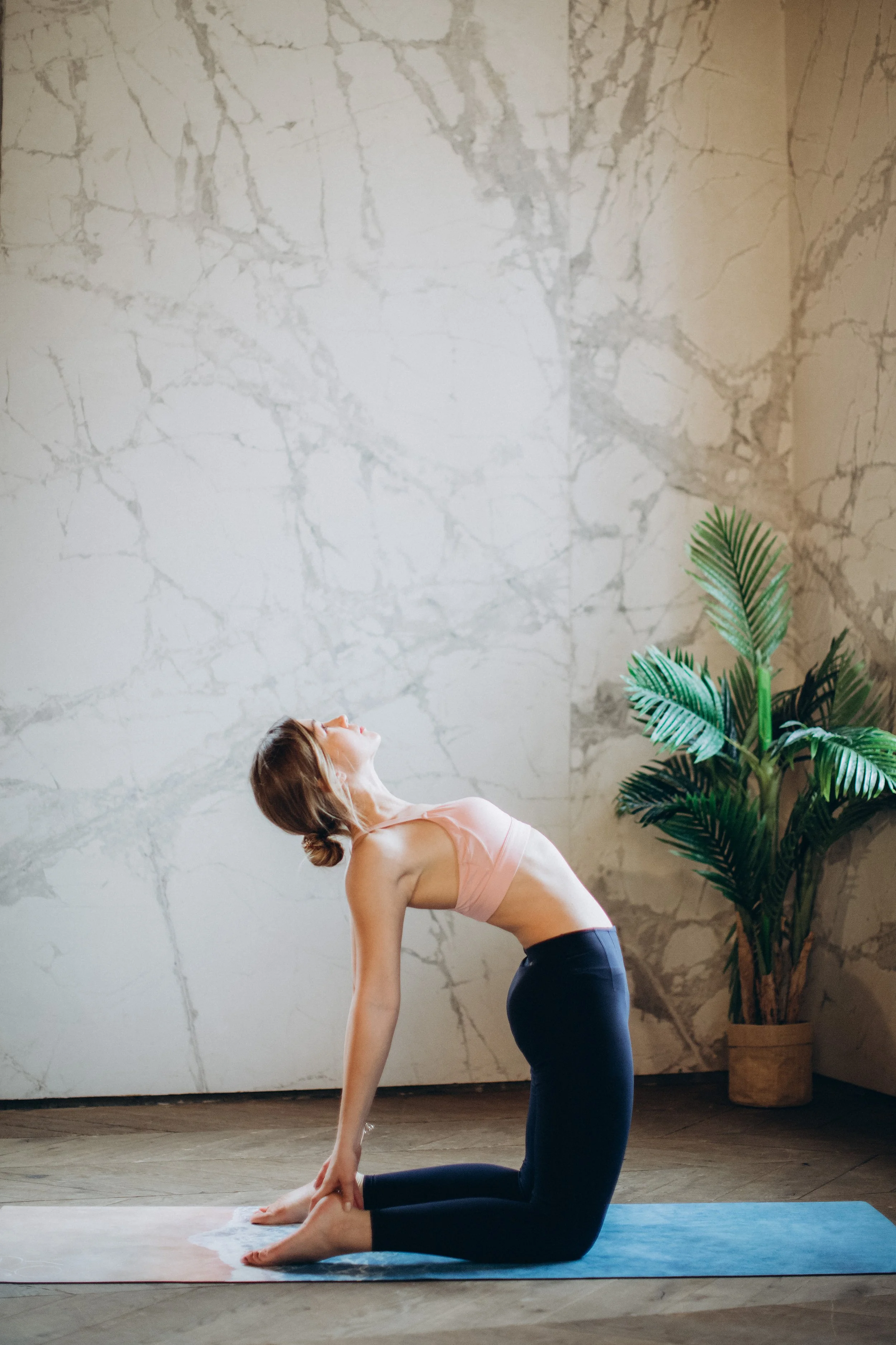woman-in-pink-tank-top-and-blue-leggings-bending-her-body-3823074.jpg