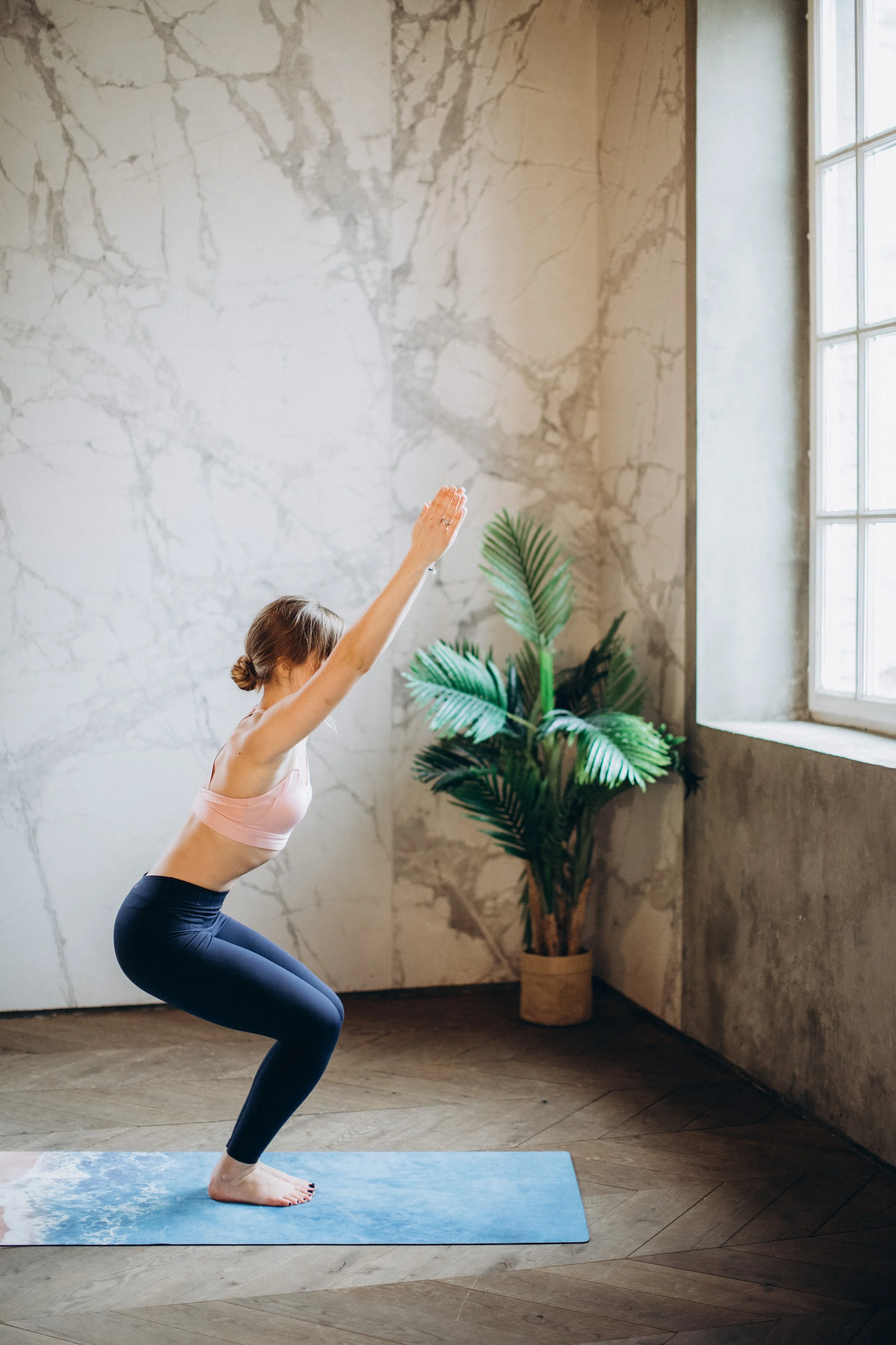 woman-in-white-tank-top-and-black-leggings-doing-yoga-on-3823075.jpg