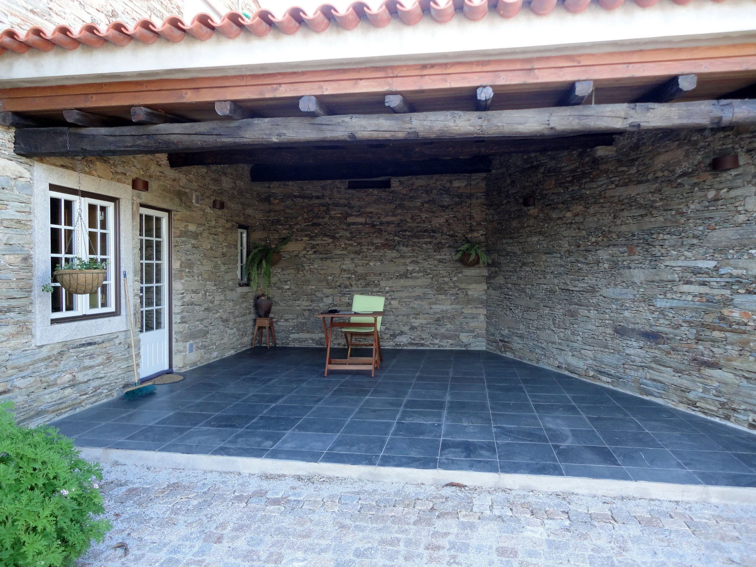 Covered porch of a renovated stone house in Cebolais de Cima, Portugal