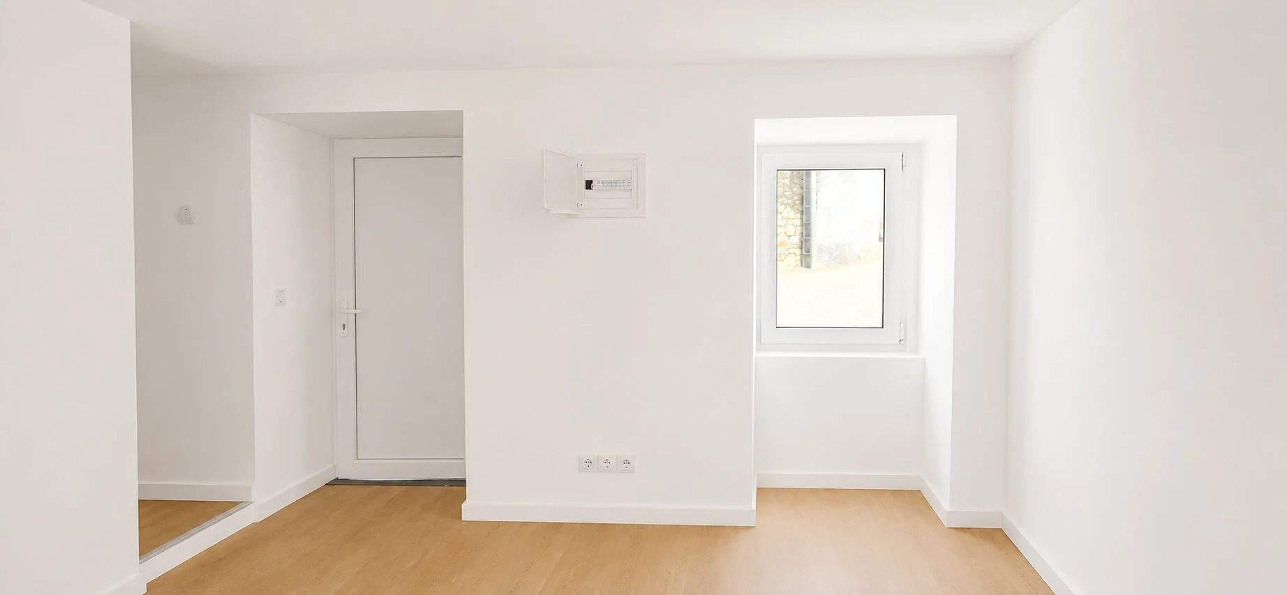 Traditional textured wall contrasting with the clean white interior and oak flooring