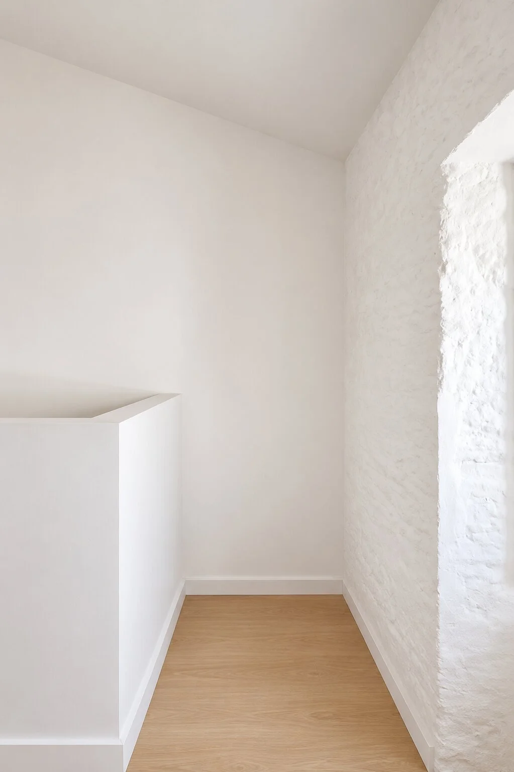  interior niche with traditional textured wall and oak flooring