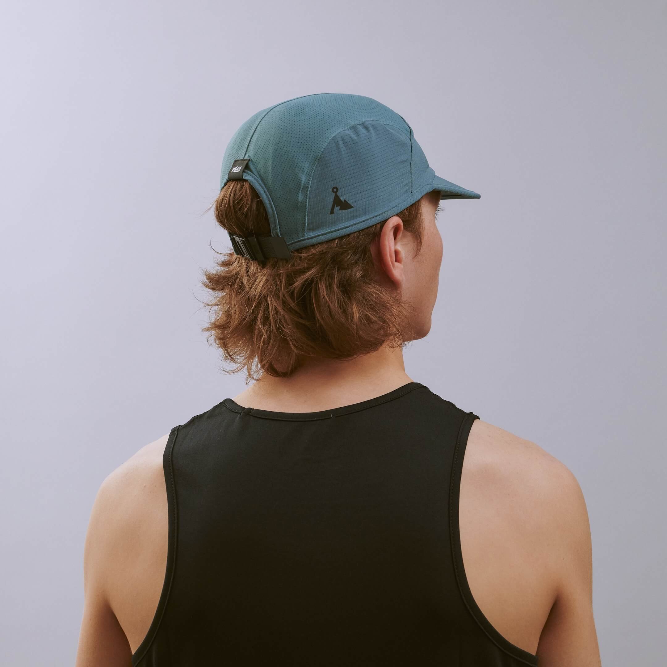 vaga-transit-lite-cap-unstructured-running-cap-teal-e-model-angle.jpg