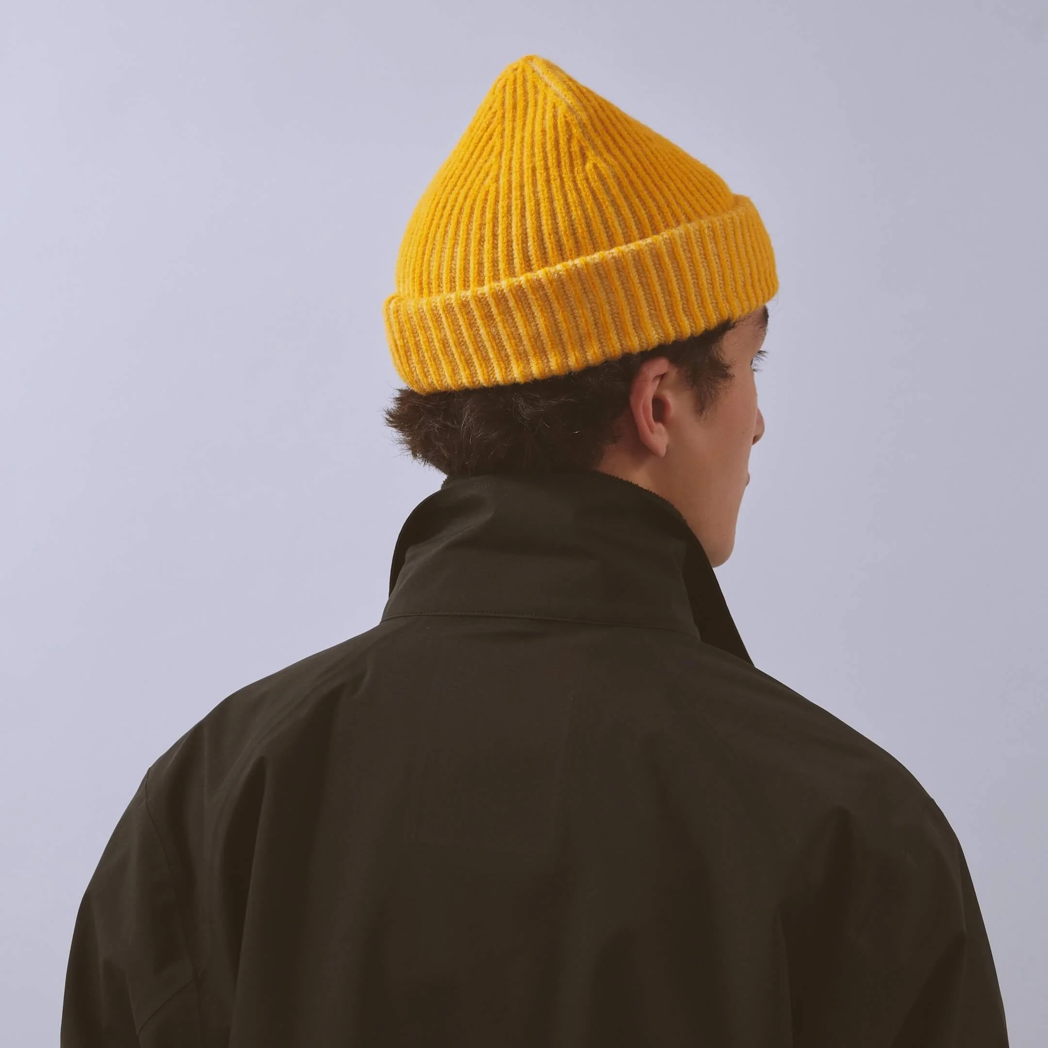 vaga-midweight-running-beanie-pale-lemon-yellow-model-back-angle.jpg