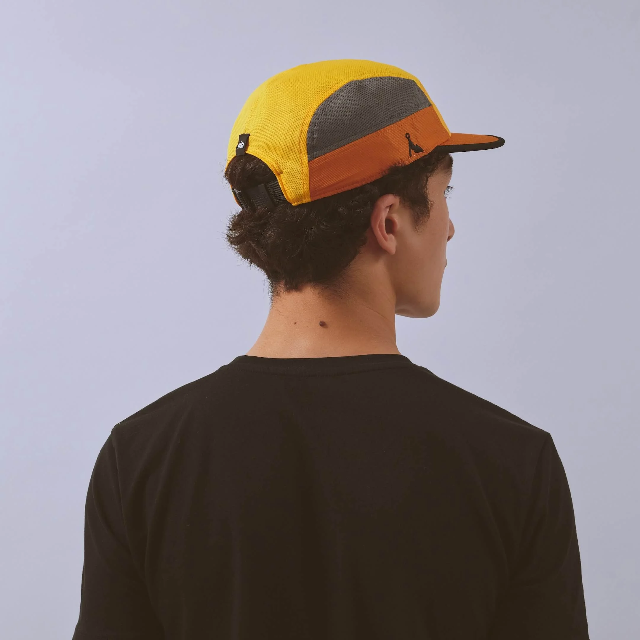 vaga-club-cap-running-cap-yellow-amber-charcoal-model-back-angle.jpg