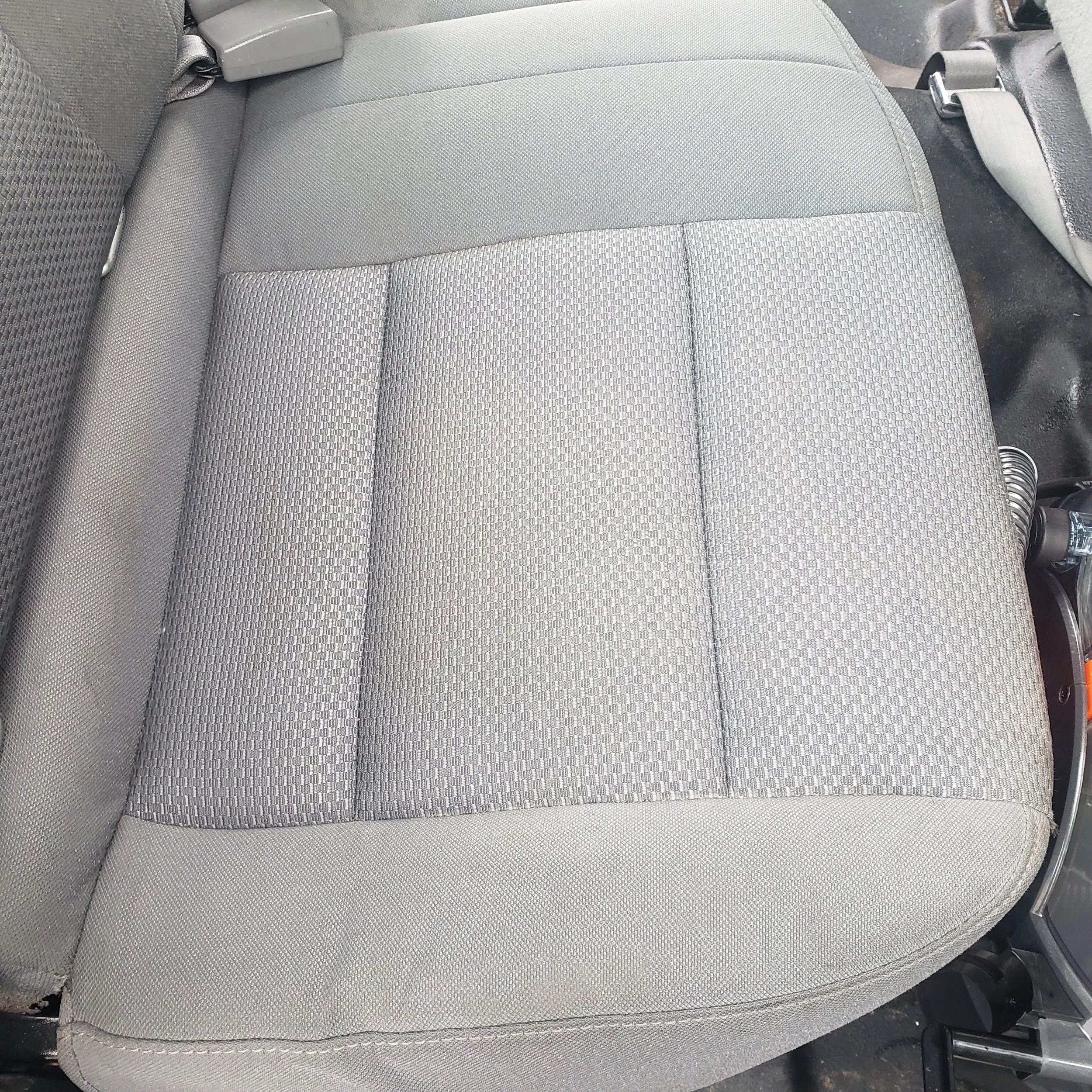 Seats after receiving interior shampoo service to remove dirt stains.