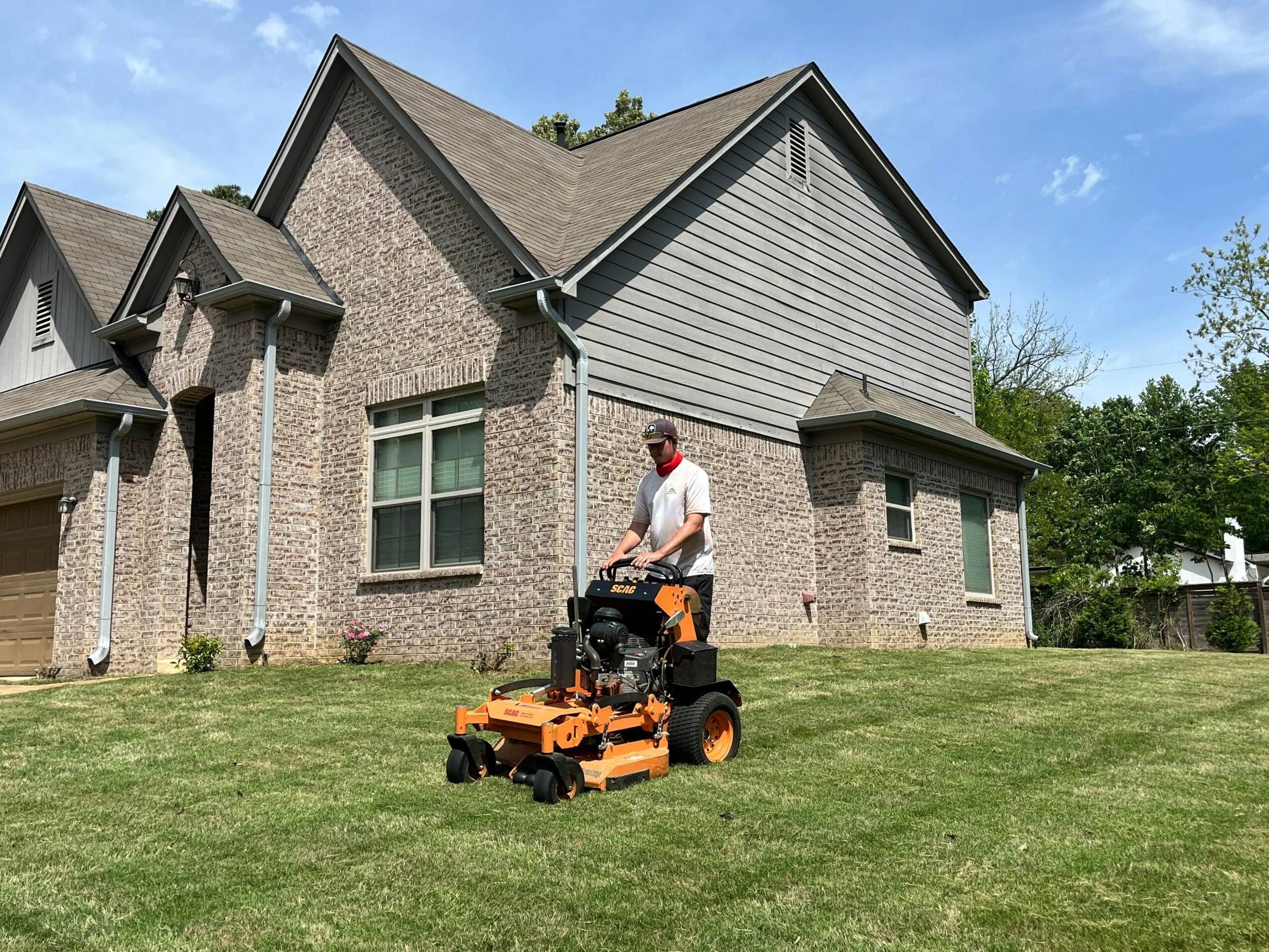 Man on mower mowing grass in Memphis, Tennessee